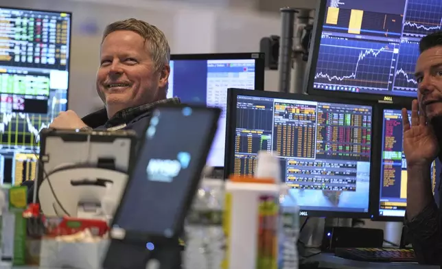 People work on the floor at the New York Stock Exchange in New York, Wednesday, April 9, 2025. (AP Photo/Seth Wenig)