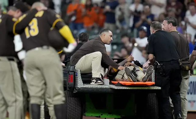 San Diego Padres' Luis Arraez gives a thumbs up as he was carted off the field after a collision with Houston Astros second baseman Mauricio Dubon during the first inning of a baseball game Sunday, April 20, 2025, in Houston. (AP Photo/Karen Warren)