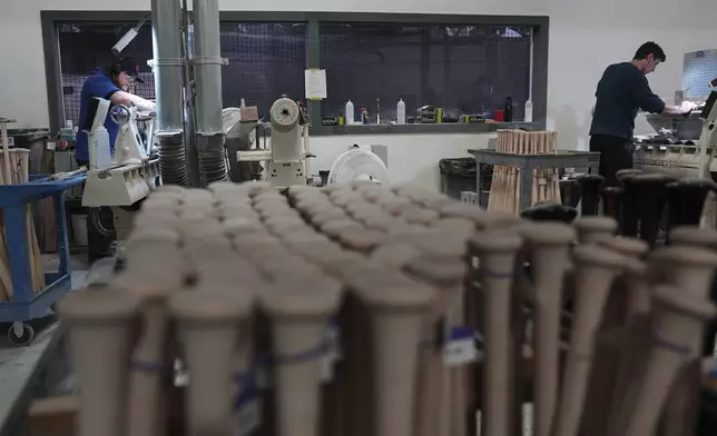 Tom Quirk, left, and Jim Levasseur manufacture torpedo baseball bats at Victus Sports in King of Prussia, Pa., Wednesday, April 2, 2025. (AP Photo/Matt Rourke)