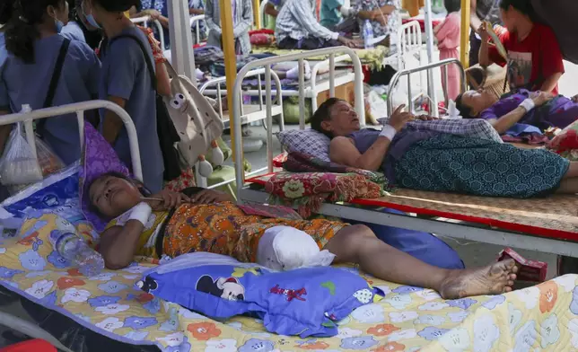 In this photo released by Xinhua News Agency, injured people receive treatment at a makeshift tent in the earthquake hit Sagaing, Myanmar, Tuesday, April 1, 2025. (Myo Kyaw Soe/Xinhua via AP)