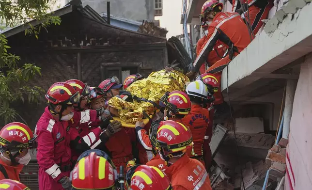 In this photo released by Xinhua News Agency, Chinese rescuers move a survivor out from a collapsed building in the aftermath of an earthquake in Mandalay, Myanmar, Wednesday, April 2, 2025. (Cai Yang/Xinhua via AP)