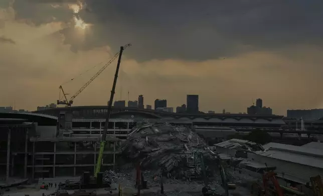 Heavy machineries are deployed to clear the rubbles from the site of an under construction high-rise building that collapsed after an earthquake in Bangkok, Thailand, Thursday, April, 3, 2025. (AP Photo/Manish Swarup)