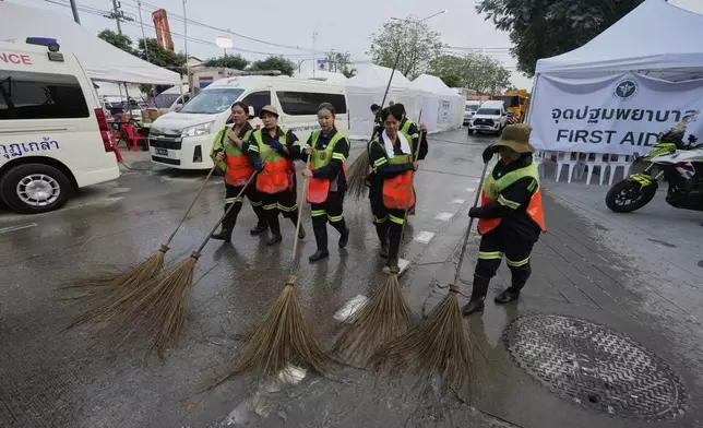 Workers clean the area around an under-construction high-rise building that collapsed after an earthquake in Bangkok, Thailand, Tuesday, April 1, 2025. (AP Photo/Manish Swarup)