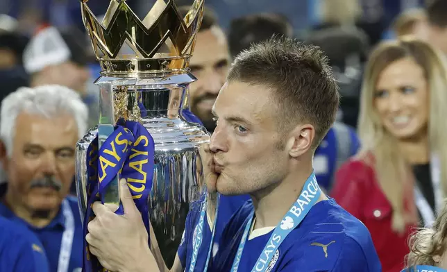 FILE - Leicester's Jamie Vardy kisses the trophy as Leicester City celebrate becoming the English Premier League soccer champions at King Power stadium in Leicester, England, Saturday, May 7, 2016. (AP Photo/Matt Dunham, File)