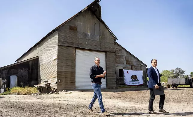 California Gov. Gavin Newsom, left, and California Attorney General Rob Bonta arrive at a press conference about President Donald Trump's tariffs on Wednesday, April 16, 2025, at an almond farm in Ceres, Calif. (AP Photo/Noah Berger)