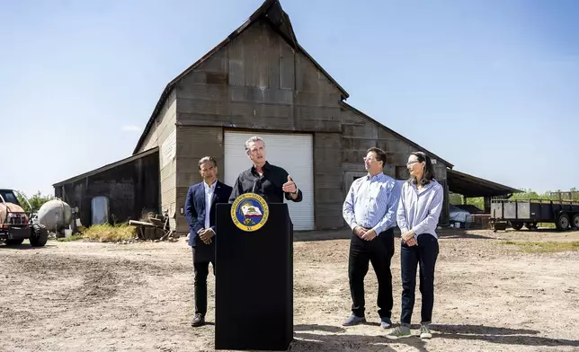 California Gov. Gavin Newsom discusses President Donald Trump's tariffs, as California Attorney General Rob Bonta, left, Sierra Pacific Warehouse Group CEO Chris Murphy and almond farmer Christine Gemperle, listen, during a press conference on Wednesday, April 16, 2025, at an almond farm in Ceres, Calif. (AP Photo/Noah Berger)