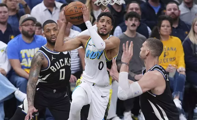 Indiana Pacers guard Tyrese Haliburton (0) shoots over Milwaukee Bucks center Brook Lopez (11) during the second half of a first-round NBA basketball playoff game in Indianapolis, Tuesday, April 22, 2025. (AP Photo/Michael Conroy)