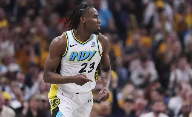 Indiana Pacers forward Aaron Nesmith (23 gestures after a basket against the Milwaukee Bucks during the second half of a first-round NBA basketball playoff game in Indianapolis, Tuesday, April 22, 2025. (AP Photo/Michael Conroy)