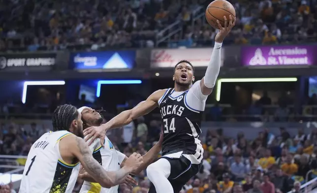 Milwaukee Bucks forward Giannis Antetokounmpo (34) shoots over Indiana Pacers center Myles Turner (33) during the first half of a first-round NBA basketball playoff game in Indianapolis, Tuesday, April 22, 2025. (AP Photo/Michael Conroy)