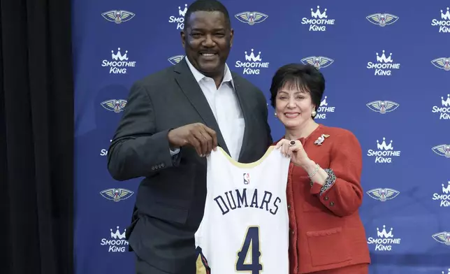 Joe Dumars, the New Orleans Pelicans executive vice president of basketball operations, left, poses with Pelicans governor Gayle Benson, who also owns NFL New Orleans Saints, after his introductory press conference in Metairie, La., Tuesday, April 22, 2025. (AP Photo/Matthew Hinton)