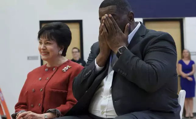 Joe Dumars, the New Orleans Pelicans executive vice president of basketball operations, wipes his eyes before speaking at his introductory press conference in Metairie, La., Tuesday, April 22, 2025. Dumars sits next to Pelicans governor Gayle Benson, who also owns the NFL New Orleans Saints. (AP Photo/Matthew Hinton)