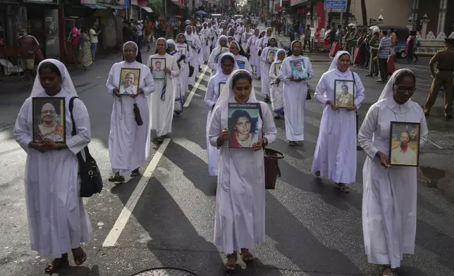 Sri Lankan Catholics nuns carry portraits of the victims of the 2019 Easter Sunday attacks during its sixth anniversary commemoration in Colombo, Sri Lanka, Monday, April 21, 2025. (AP Photo/Eranga Jayawardena)