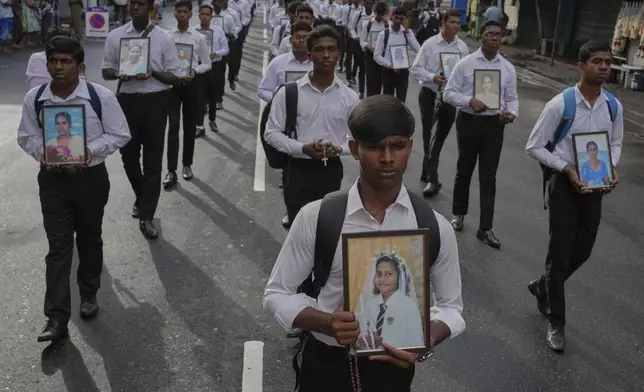 Sri Lankan Catholics carry portraits of the victims of the 2019 Easter Sunday attacks during its sixth anniversary commemoration in Colombo, Sri Lanka, Monday, April 21, 2025. (AP Photo/Eranga Jayawardena)