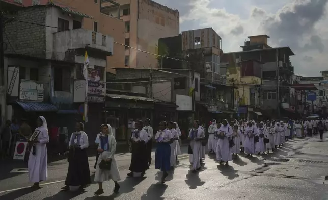 Sri Lankan Catholics nuns carry portraits of the victims of the 2019 Easter Sunday attacks during its sixth anniversary commemoration in Colombo, Sri Lanka, Monday, April 21, 2025. (AP Photo/Eranga Jayawardena)
