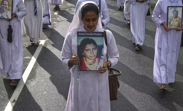 Sri Lankan Catholics nuns carry portraits of the victims of the 2019 Easter Sunday attacks during its sixth anniversary commemoration in Colombo, Sri Lanka, Monday, April 21, 2025. (AP Photo/Eranga Jayawardena)