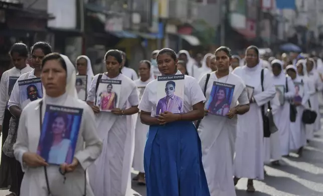Sri Lankan Catholics nuns carry portraits of the victims of the 2019 Easter Sunday attacks during its sixth anniversary commemoration in Colombo, Sri Lanka, Monday, April 21, 2025. (AP Photo/Eranga Jayawardena)