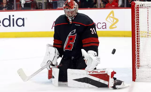 Carolina Hurricanes goaltender Frederik Andersen (31) watches the puck against the New Jersey Devils during the third period of Game 1 of an NHL hockey Stanley Cup first-round playoff series in Raleigh, N.C., Sunday, April 20, 2025. (AP Photo/Karl DeBlaker)