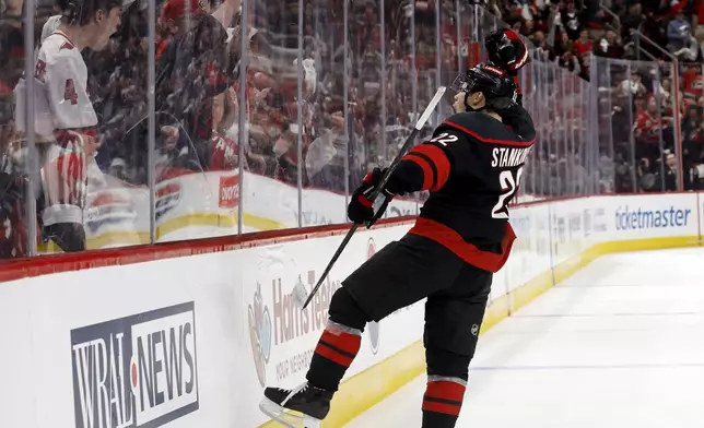 Carolina Hurricanes' Logan Stankoven (22) celebrates his goal against the New Jersey Devils during the second period of Game 1 of an NHL hockey Stanley Cup first-round playoff series in Raleigh, N.C., Sunday, April 20, 2025. (AP Photo/Karl DeBlaker)
