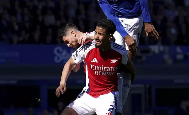 Everton's Beto, top, and Arsenal's William Saliba battle for the ballduring the English Premier League soccer match between Everton and Arsenal at Goodison Park, Liverpool, England, Saturday, April 5, 2025. (Martin Rickett/PA via AP)
