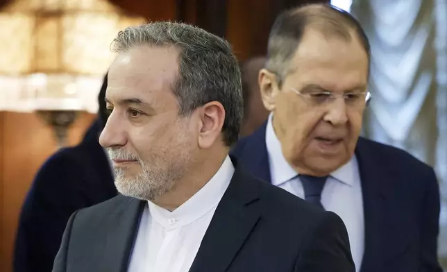 Iranian Foreign Minister Abbas Araghchi, left, and Russian Foreign Minister Sergey Lavrov enter a hall prior to their meeting in Moscow, Russia, Friday, April 18, 2025. (Tatyana Makeyeva/Pool Photo via AP)