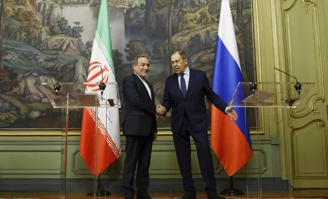 Iranian Foreign Minister Abbas Araghchi, left, and Russian Foreign Minister Sergey Lavrov shake hands after the news conference following their meeting in Moscow, Russia, Friday, April 18, 2025. (Tatyana Makeyeva/Pool Photo via AP)