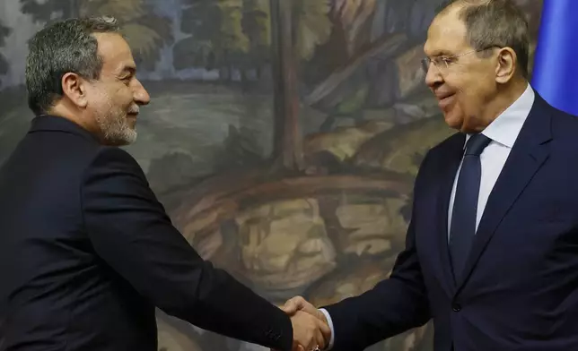 Iranian Foreign Minister Abbas Araghchi, left, and Russian Foreign Minister Sergey Lavrov shake hands after a news conference following their meeting in Moscow, Russia, Friday, April 18, 2025. (Tatyana Makeyeva/Pool Photo via AP)