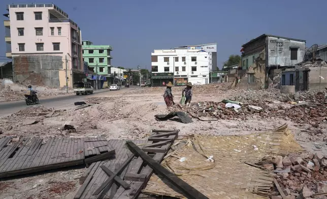 Volunteers help to clear collapsed buildings after one month of the strong earthquake in Naypyitaw, Myanmar, Monday, April 28, 2025. (AP Photo/Aung Shine Oo)