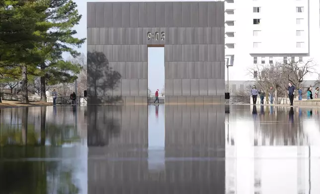 Visitors walk around the Reacting Pond at the Oklahoma City National Memorial &amp; Museum in Oklahoma City on March 12, 2025. (AP Photo/LM Otero)