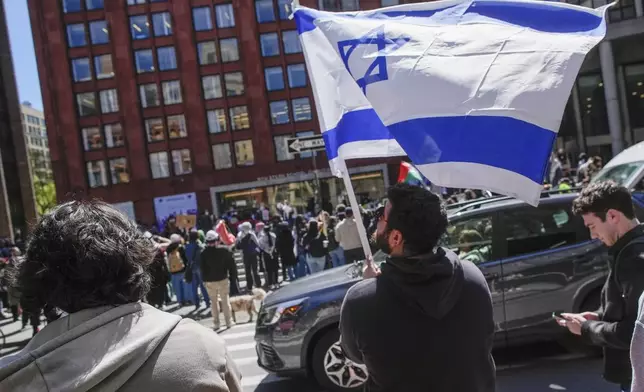 FILE - New York University students and pro-Israeli supporters rally across the street from where pro-Palestinian students and supporters rally outside the NYU Stern School of Business building, April 22, 2024, in New York. (AP Photo/Mary Altaffer, File)