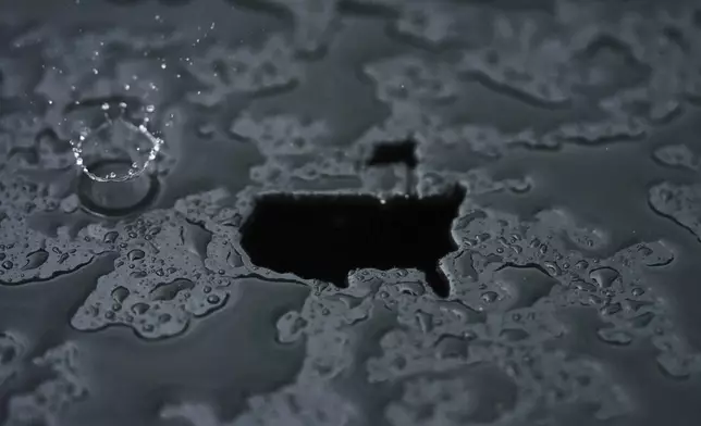 A rain droplet falls on a Masters logo cut out during a practice round at the Masters golf tournament, Monday, April 7, 2025, in Augusta, Ga. (AP Photo/Matt Slocum)