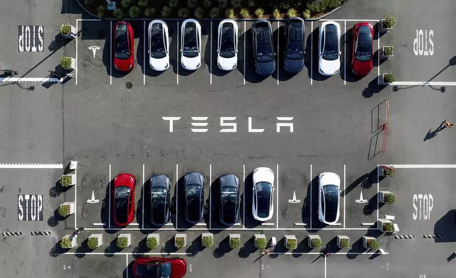FILE - Tesla vehicles line a parking lot at the company's Fremont, Calif., factory on Sept. 18, 2023. (AP Photo/Noah Berger, file)