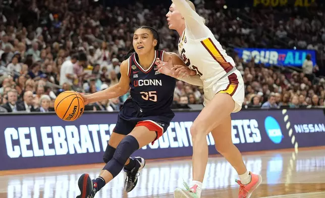 UConn guard Azzi Fudd (35) drives to the basket against South Carolina forward Chloe Kitts (21) during the second half of the national championship game at the Final Four of the women's NCAA college basketball tournament, Sunday, April 6, 2025, in Tampa, Fla. (AP Photo/John Raoux)