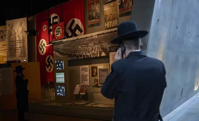 People visit the Yad Vashem Holocaust Memorial Museum in Jerusalem, Tuesday, April 22, 2025, ahead of the annual Holocaust remembrance day which begins at sundown Wednesday. (AP Photo/Ohad Zwigenberg)