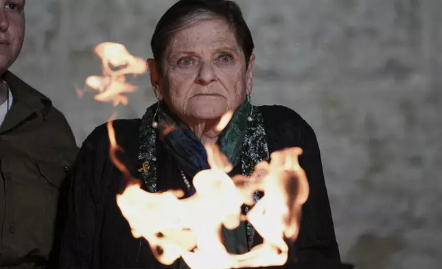 Holocaust survivor Monika Barzel lights a torch during the opening ceremony of the Holocaust Remembrance Day at the Yad Vashem Holocaust Memorial Museum in Jerusalem on Wednesday, April 23, 2025. (AP Photo/Leo Correa)