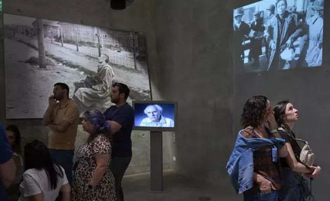People visit the Yad Vashem Holocaust Memorial Museum in Jerusalem, Tuesday, April 22, 2025, ahead of the annual Holocaust remembrance day which begins at sundown Wednesday. (AP Photo/Ohad Zwigenberg)