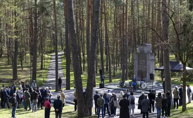 People gather at the Paneriai memorial in memory of the Jewish people of Vilnius killed by Nazis during World War II, during a Yom HaShoah (Holocaust Remembrance Day) in Vilnius, Lithuania, Thursday, April 24, 2025. (AP Photo/Mindaugas Kulbis)