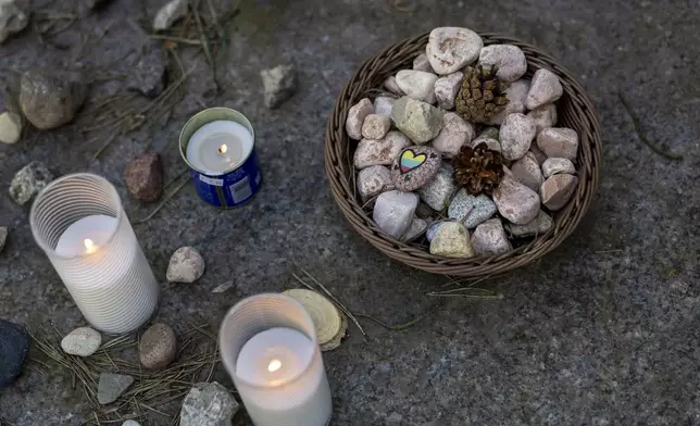 Stones are placed at the foot of a granite Holocaust survivor memorial in the Paneriai, in memory of the Jews of Vilnius killed by the Nazi during World War II, during a Yom HaShoah (Holocaust Remembrance Day) in Vilnius, Lithuania, Thursday, April 24, 2025. (AP Photo/Mindaugas Kulbis)