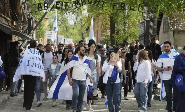 People attend the "March of the Living", the annual Holocaust remembrance event in memory of the six million Holocaust victims, at the former Nazi German death camp of Auschwitz-Birkenau in Oswiecim, Poland, Thursday, April 24, 2025. (AP Photo/Czarek Sokolowski)