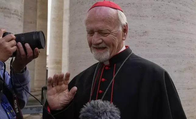 Cardinal Vicente Bokalic Iglic, from Argentina, is approached by reporters as he arrives for a college of cardinals' meeting, at the Vatican, Monday, April 28, 2025. (AP Photo/Gregorio Borgia)