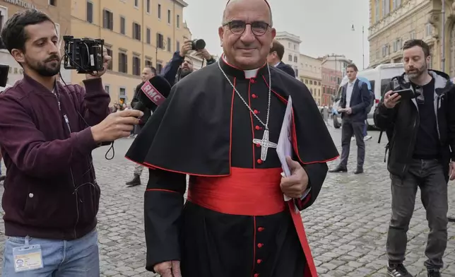 Cardinal Fernando Natalio Chomalí Garib is approached by reporters as he arrives for a college of cardinals' meeting, at the Vatican, Monday, April 28, 2025. (AP Photo/Gregorio Borgia)