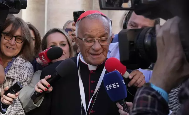 Cardinal Jorge Enrique Jiménez Carvajal is surrounded by reporters as he arrives for a college of cardinals' meeting, at the Vatican, Wednesday, April 30, 2025. (AP Photo/Gregorio Borgia)
