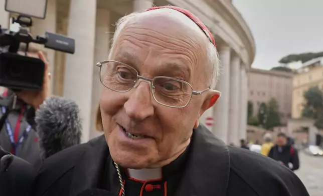 Cardinal Fernando Filoni is approached by reporters as he arrives for a college of cardinals' meeting, at the Vatican, Monday, April 28, 2025. (AP Photo/Gregorio Borgia)