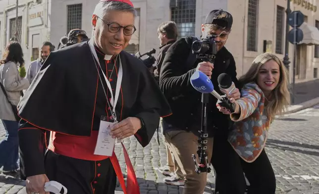 Cardinal Stephen Chow Sau-yan is approached by reporters as he arrives for a college of cardinals' meeting, at the Vatican, Wednesday, April 30, 2025. (AP Photo/Gregorio Borgia)