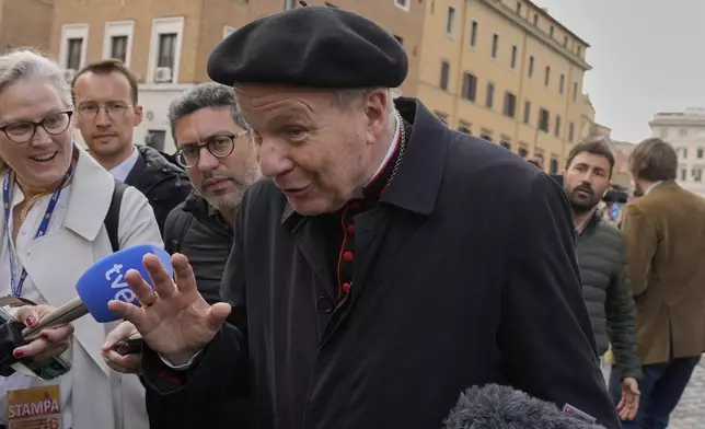 Cardinal Christoph Schönborn is approached by reporters as he arrives for a college of cardinals' meeting, at the Vatican, Monday, April 28, 2025. (AP Photo/Gregorio Borgia)