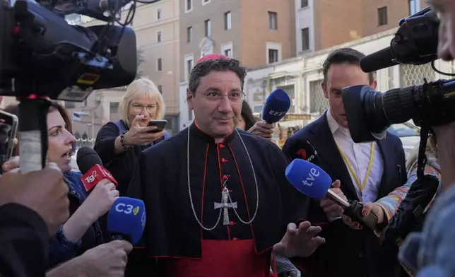 Canadian Cardinal Francis Leo is approached by reporters as he arrives for a college of cardinals' meeting, at the Vatican, Wednesday, April 30, 2025. (AP Photo/Gregorio Borgia)