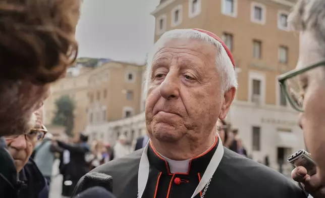 Cardinal Giuseppe Versaldi is approached by reporters as he arrives for a college of cardinals' meeting, at the Vatican, Monday, April 28, 2025. (AP Photo/Gregorio Borgia)