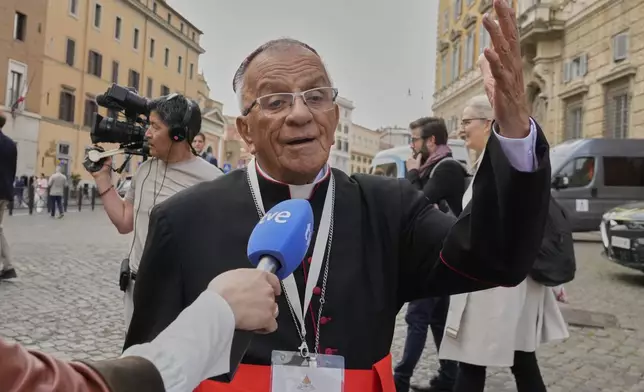 Cardinal Jorge Enrique Jiménez Carvajal is approached by a reporter as he arrives for a college of cardinals' meeting, at the Vatican, Monday, April 28, 2025. (AP Photo/Gregorio Borgia)