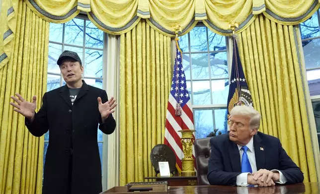 President Donald Trump listens as Elon Musk speaks in the Oval Office at the White House, Tuesday, Feb. 11, 2025, in Washington. (AP Photo/Alex Brandon)