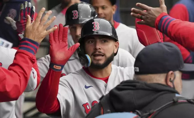 Boston Red Sox's Wilyer Abreu celebrates with teammates after scoring on a two-run double by Boston Red Sox's Trevor Story during the sixth inning of a baseball game against the Chicago White Sox in Chicago, Sunday, April 13, 2025. (AP Photo/Nam Y. Huh)