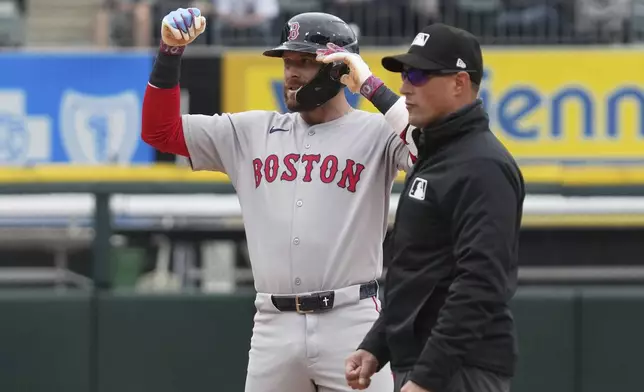 Boston Red Sox's Trevor Story celebrates after hitting a two-run double during the sixth inning of a baseball game against the Chicago White Sox in Chicago, Sunday, April 13, 2025. (AP Photo/Nam Y. Huh)